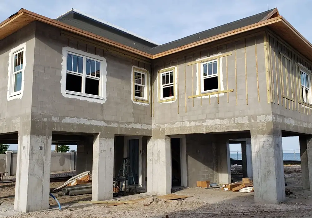 Elevated home on concrete columns with block walls ready for stucco