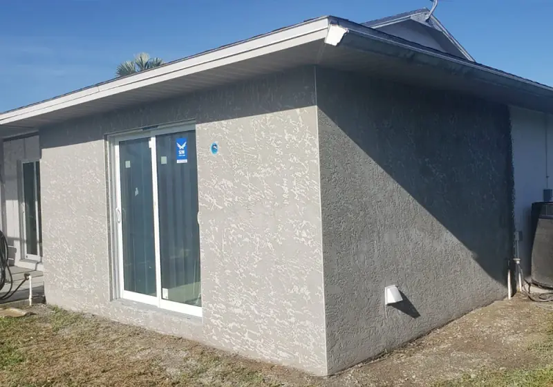 Block home addition finished with textured stucco