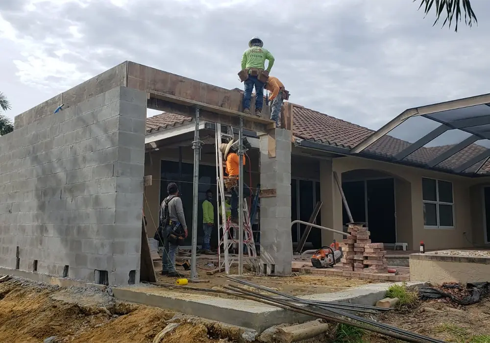 Diamonds crew setting tie beam forms on a block home addition